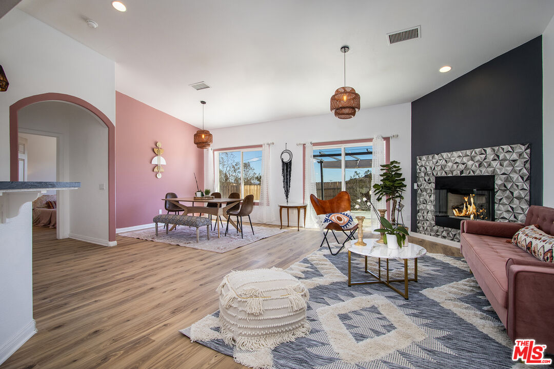 a living room with furniture fireplace and window