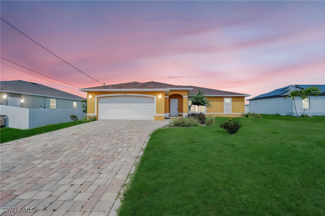 a front view of a house with a yard and garage