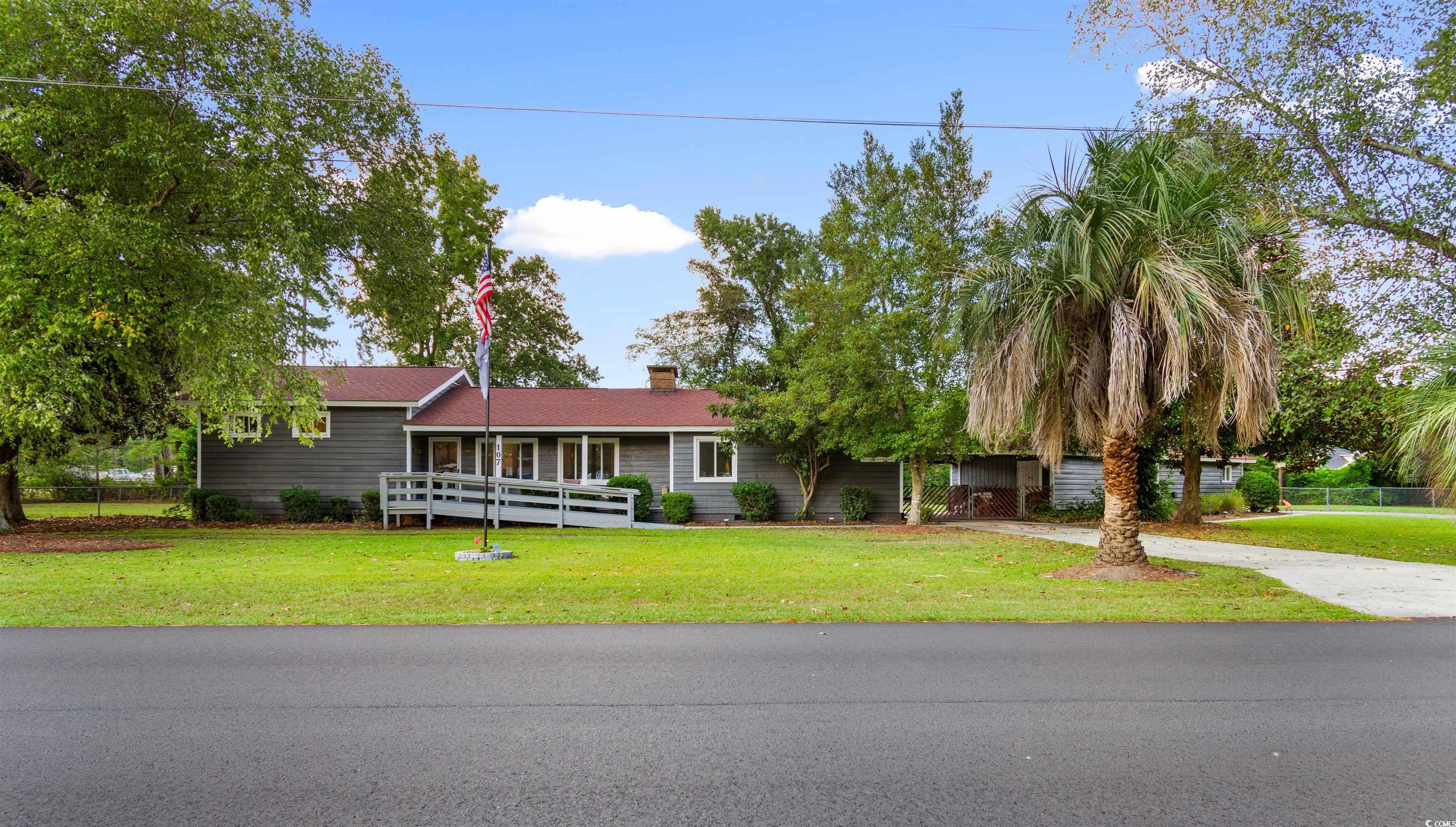 Ranch-style home featuring a front yard