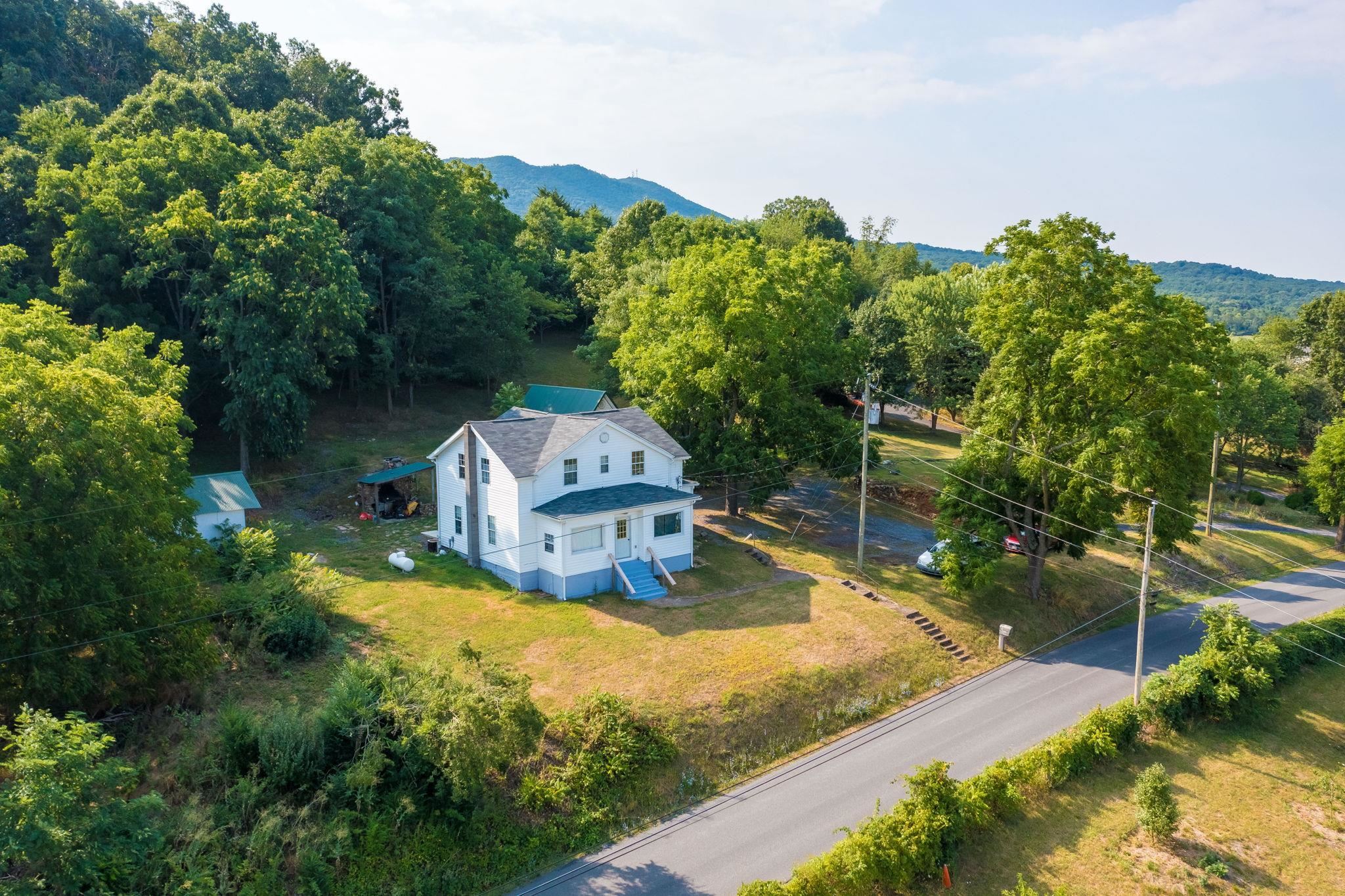 an aerial view of a house with yard swimming pool and outdoor seating