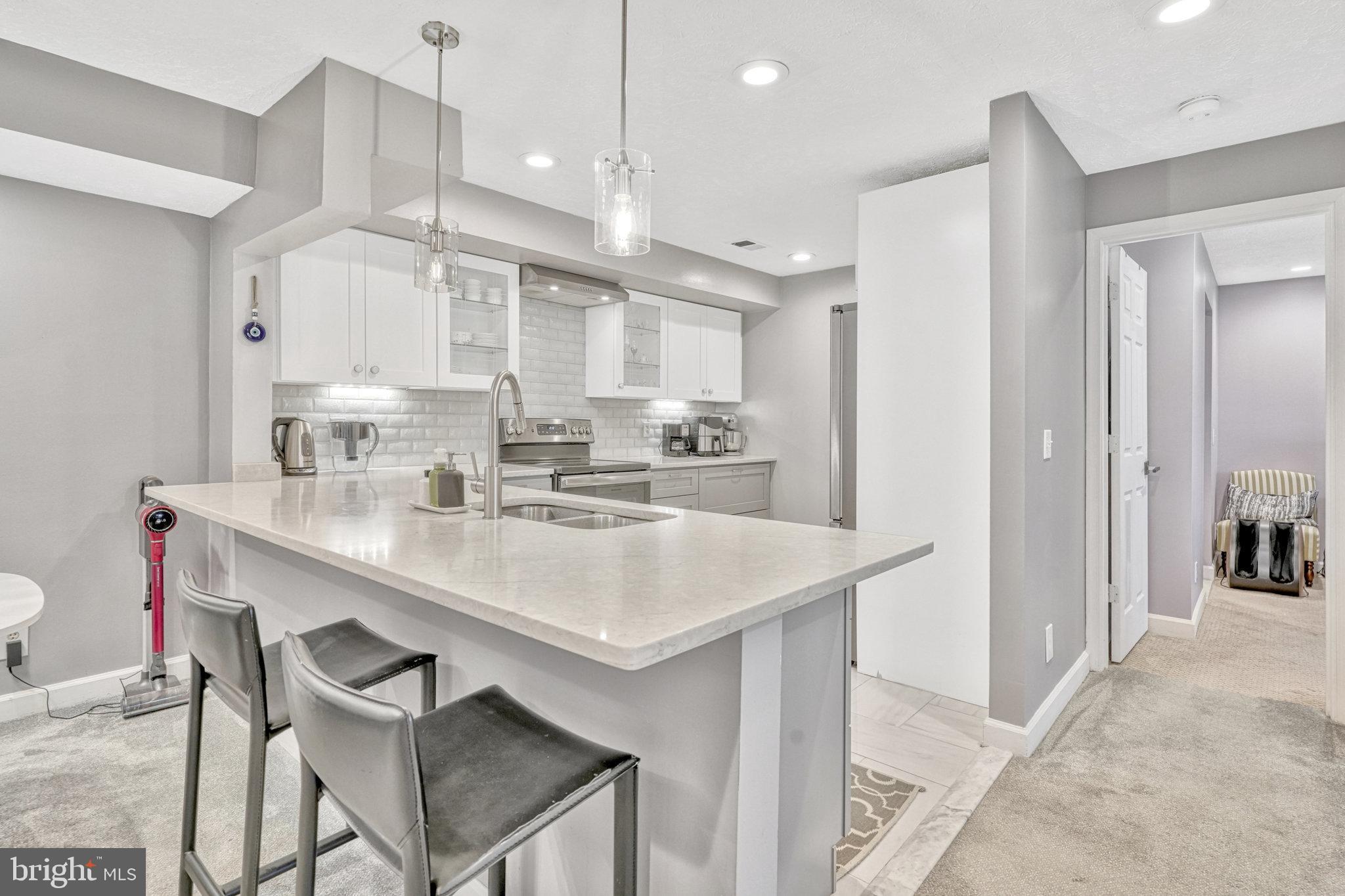 a kitchen with kitchen island a sink dining table and chairs