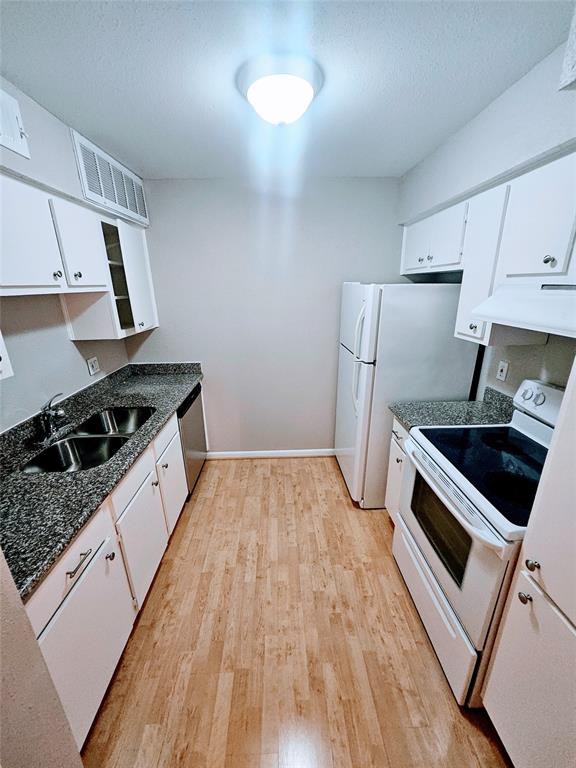 a kitchen with a stove and a refrigerator