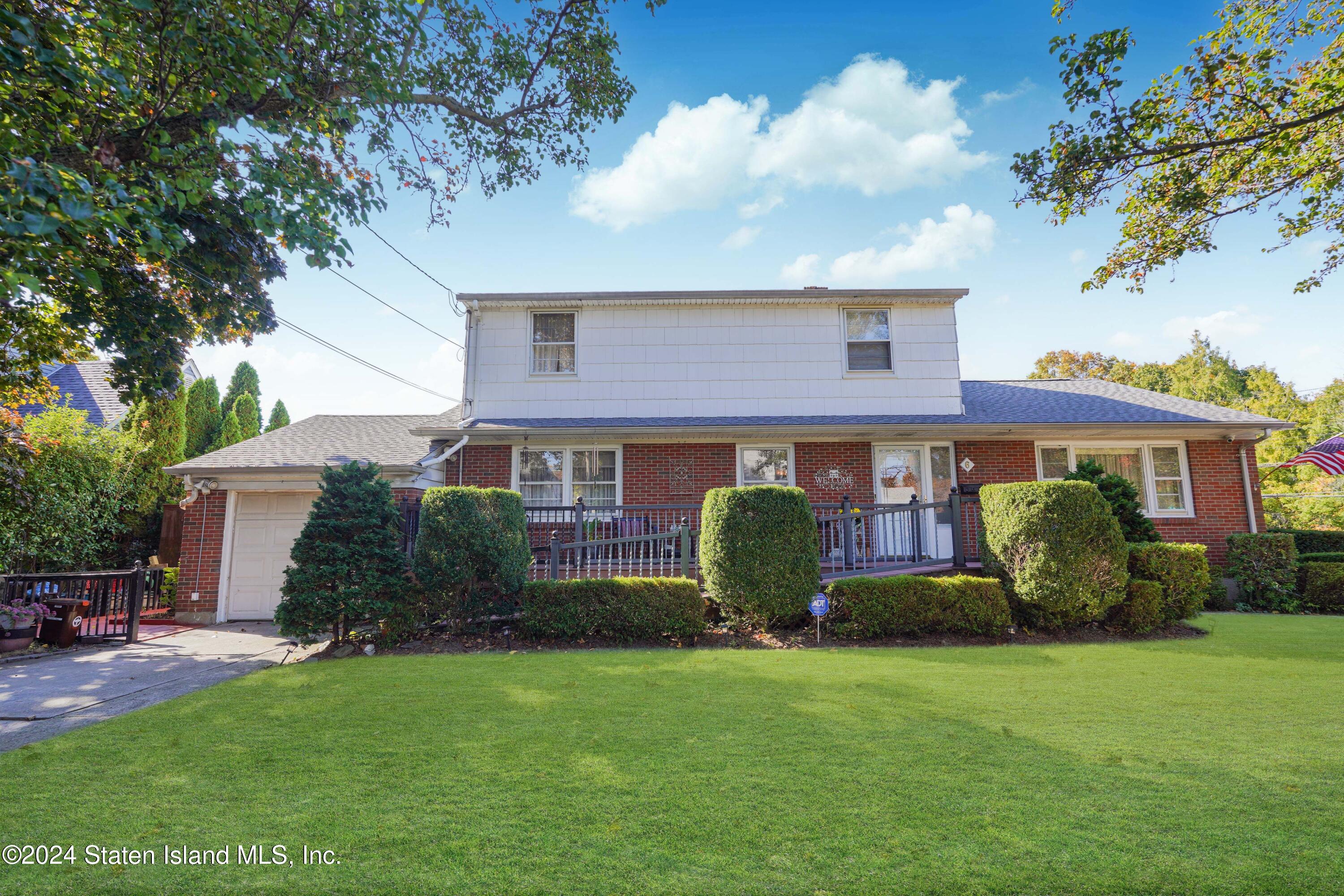 a front view of house with yard and outdoor seating