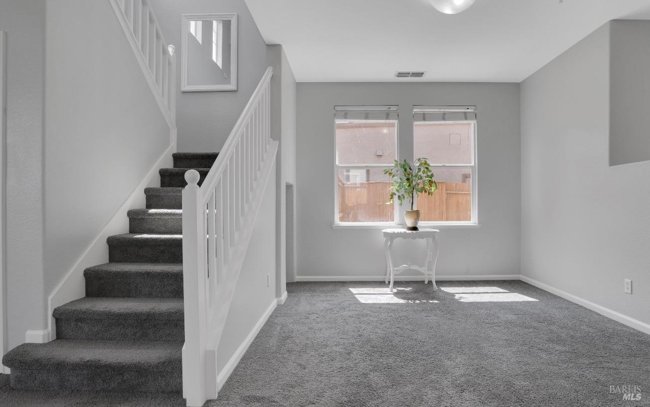 an empty room with windows and entryway