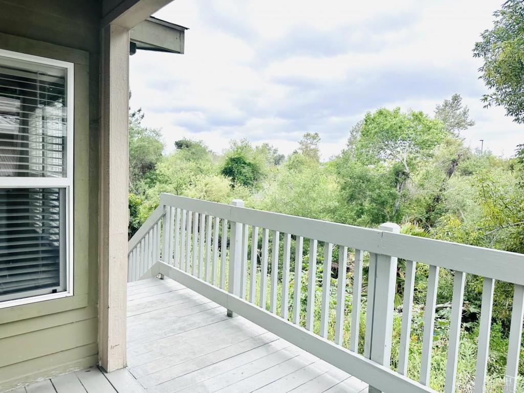 a balcony with trees in front of it