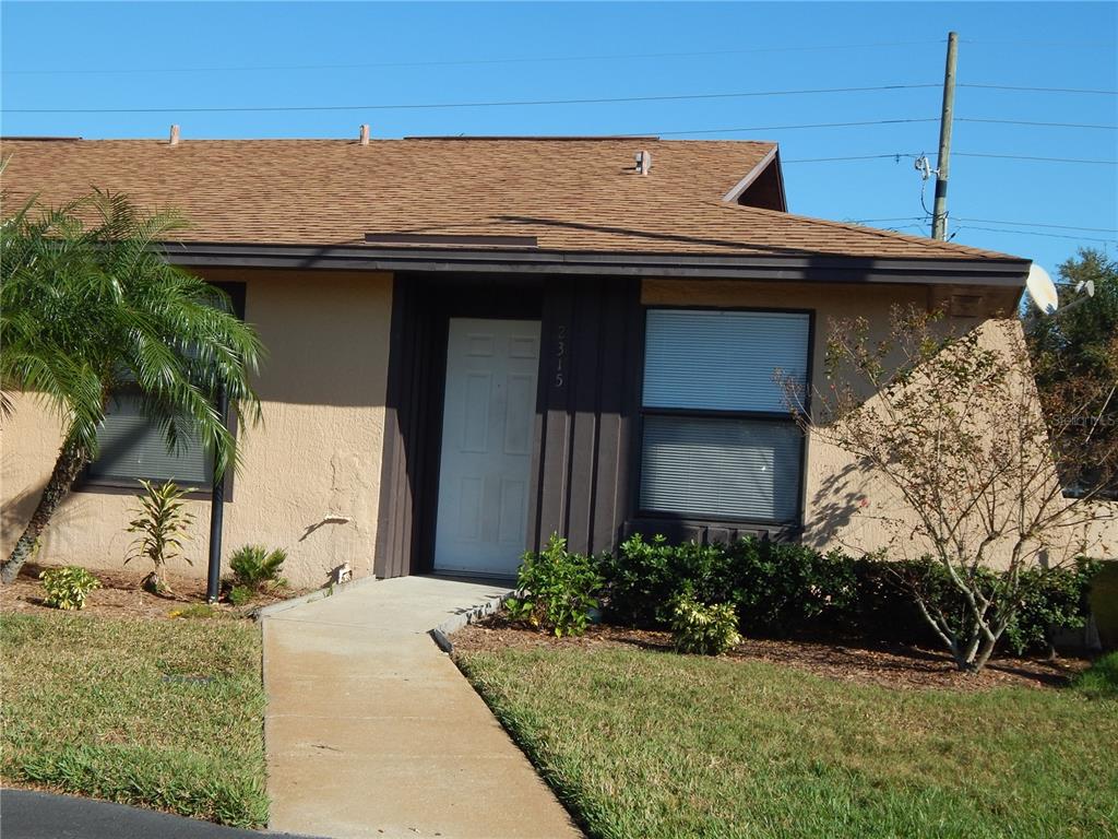 a view of a house with a yard