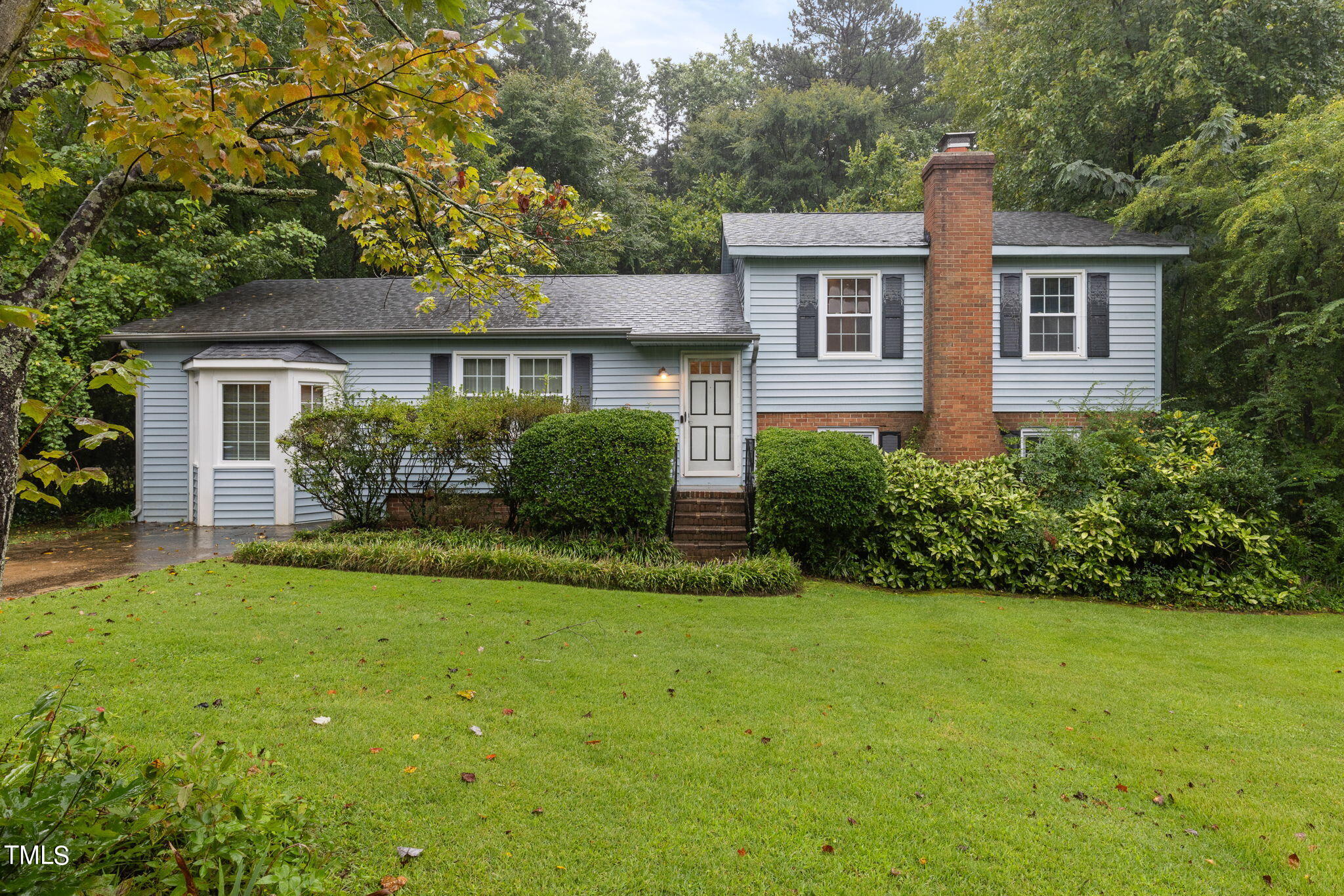 a front view of a house with a garden