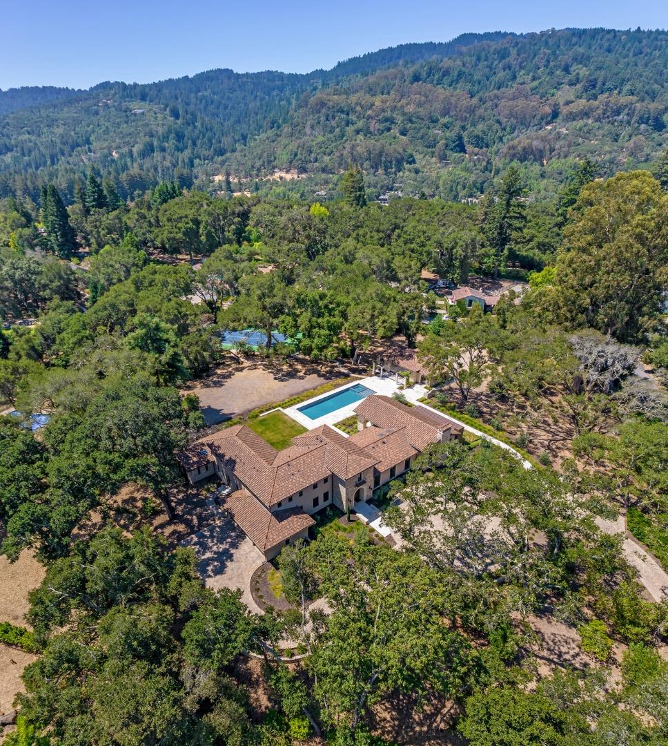 an aerial view of a house with a yard