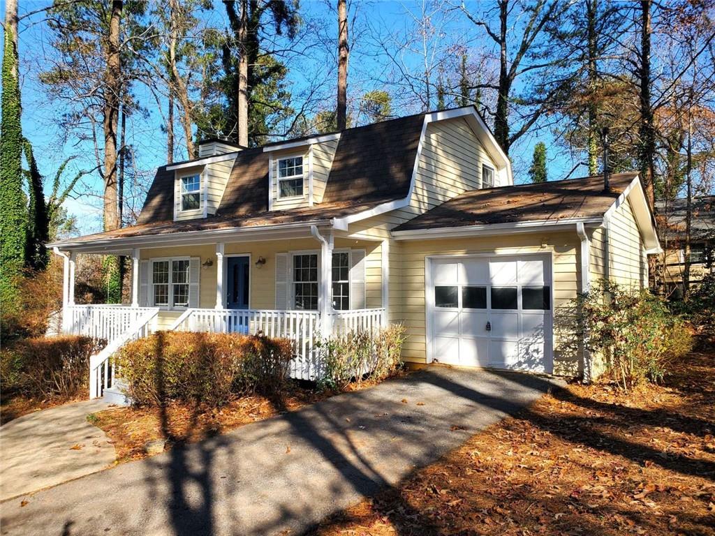 a front view of a house with yard porch and furniture