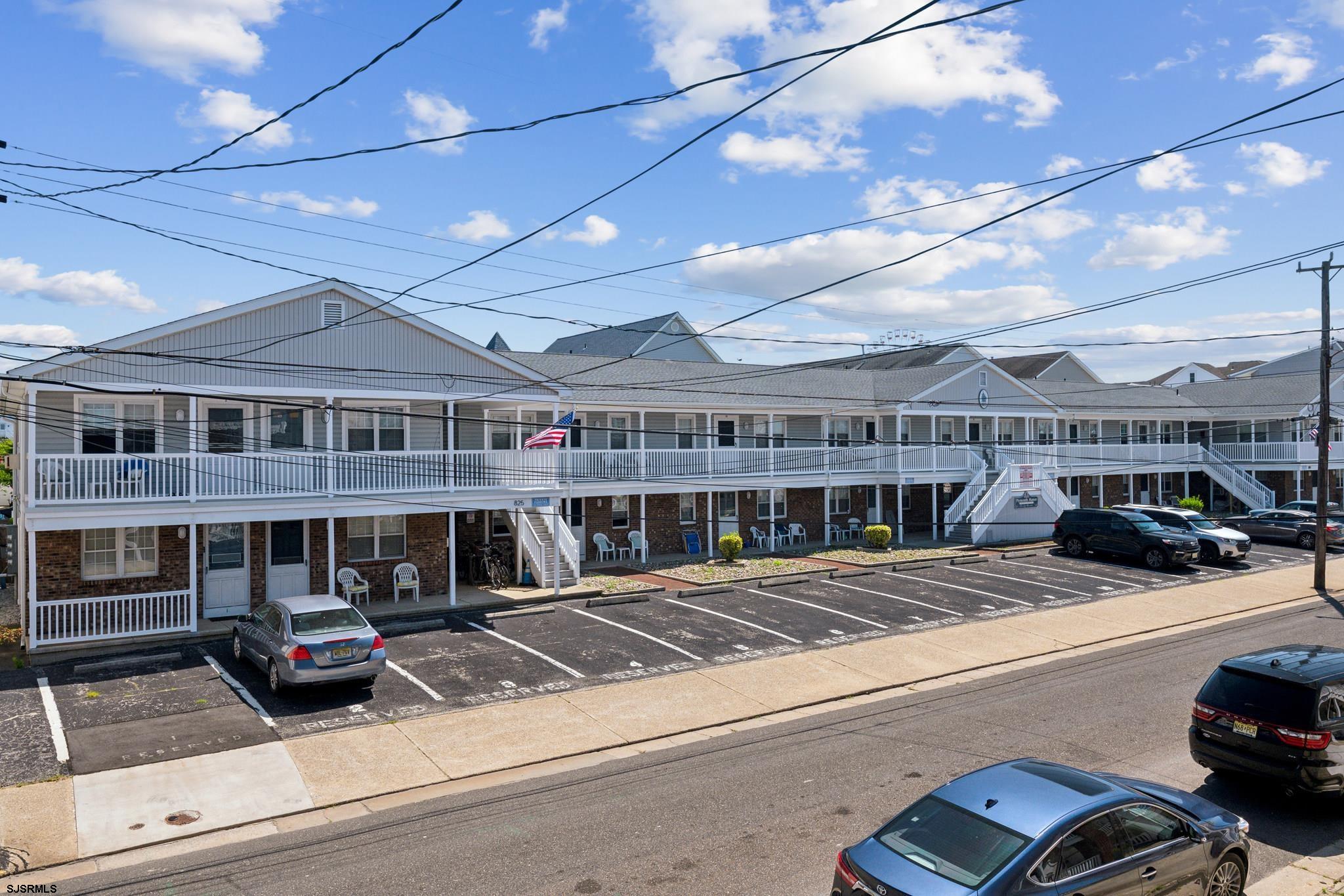 a view of a building with cars parked