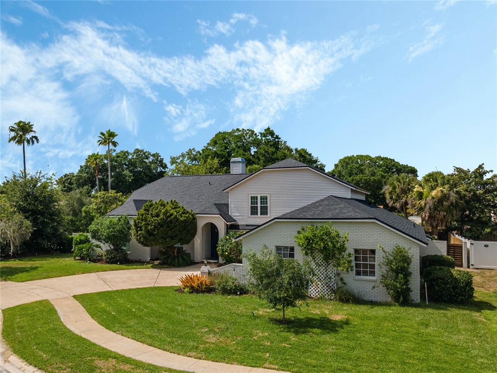 a front view of house with yard and green space