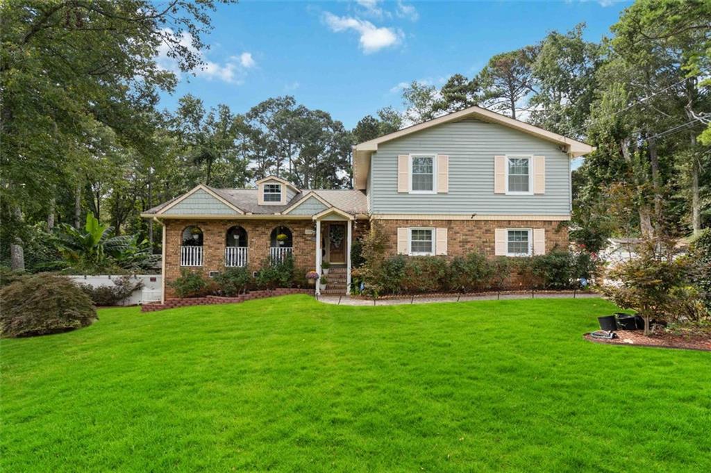 a front view of a house with a garden