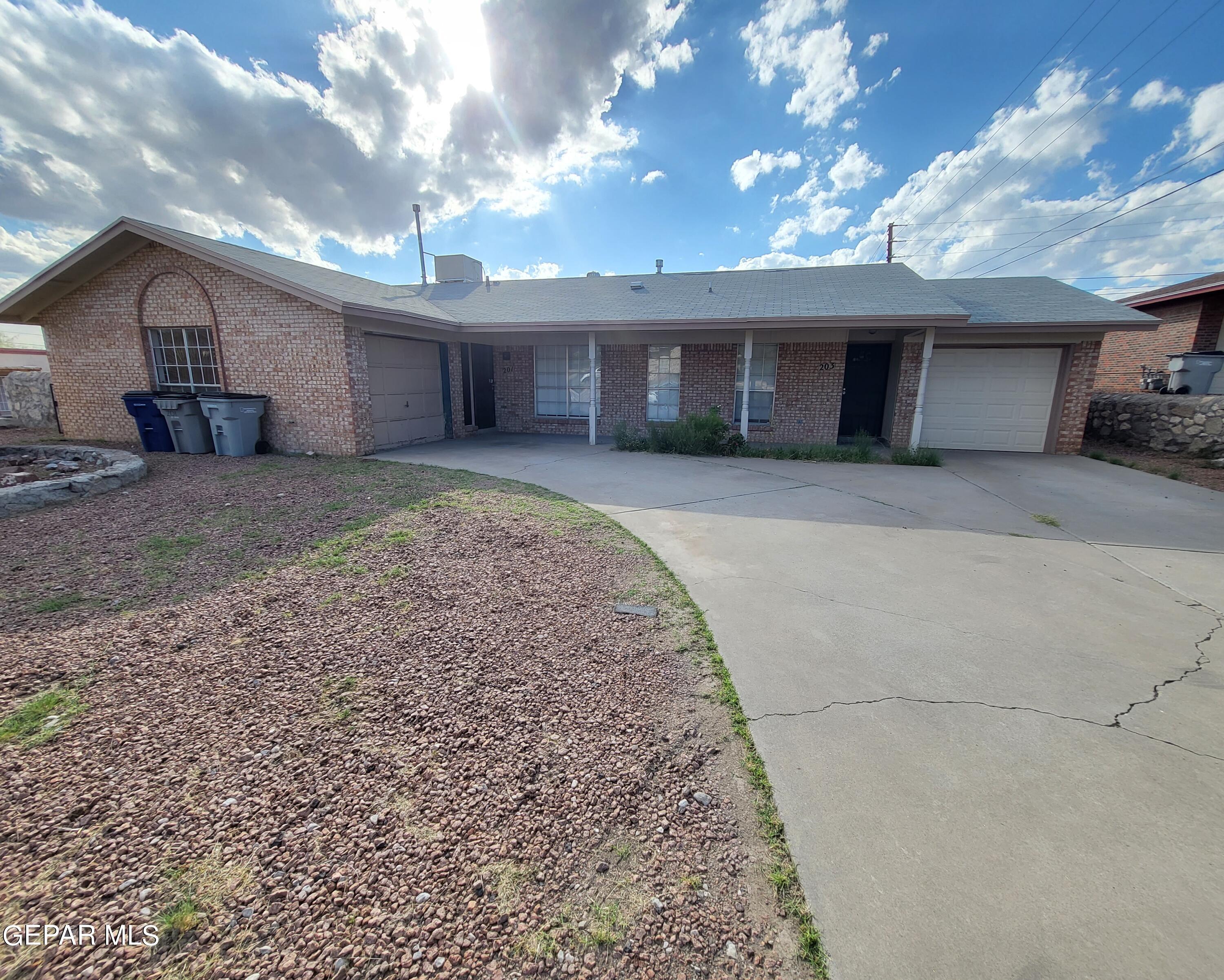 a view of a house with a yard and garage