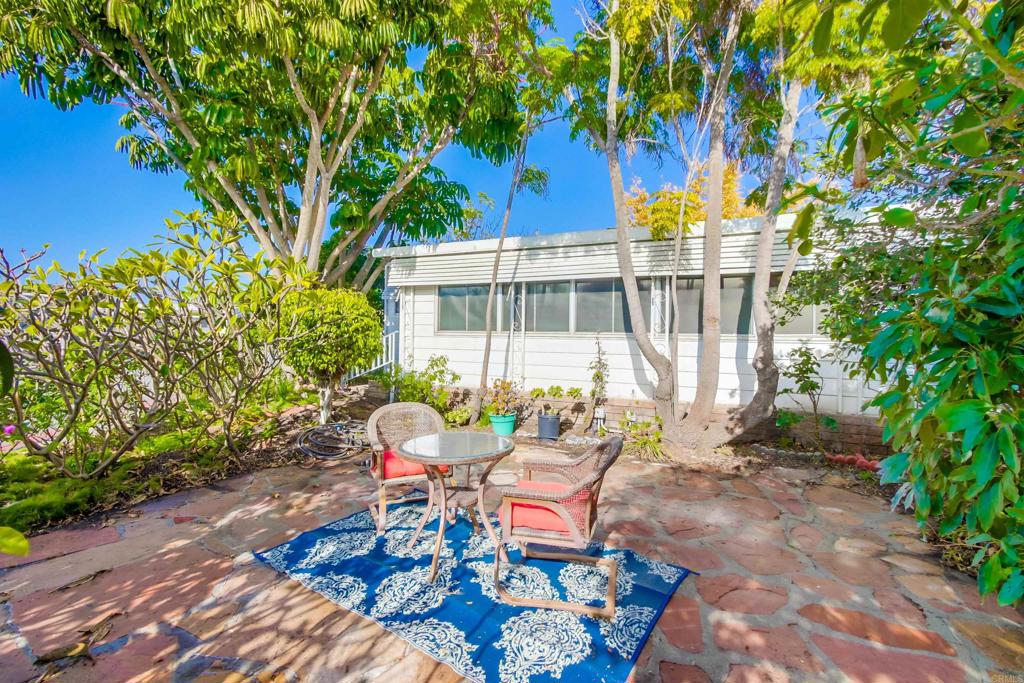 a backyard of a house with table and chairs