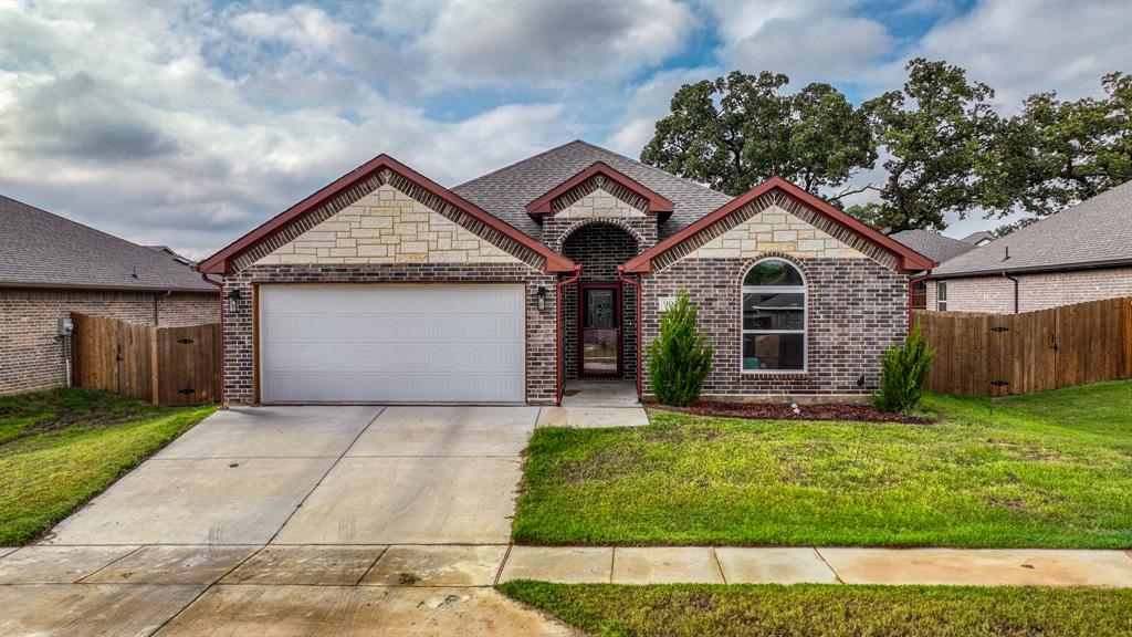 a front view of a house with a yard and garage