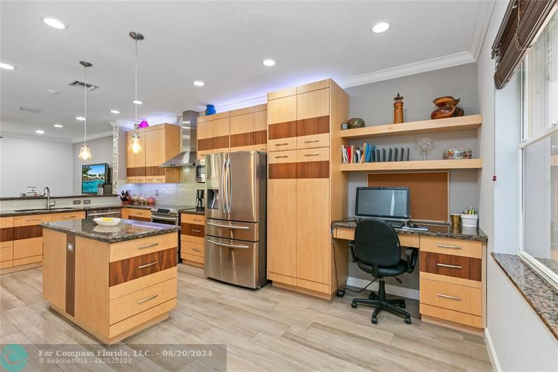 a kitchen with a sink appliances and cabinets