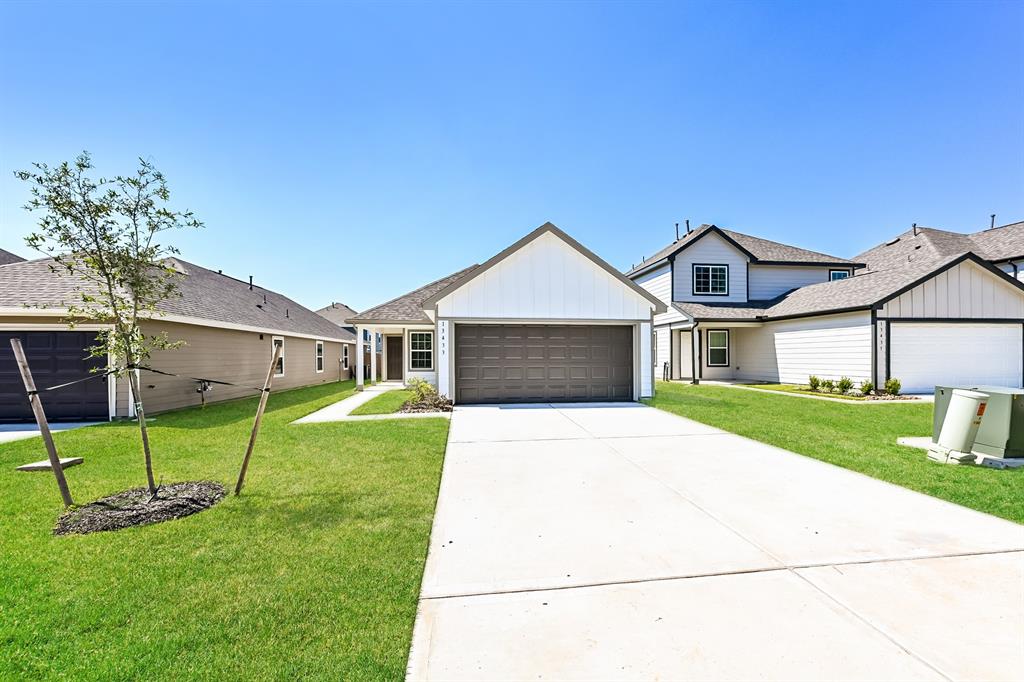 a front view of a house with a yard and garage