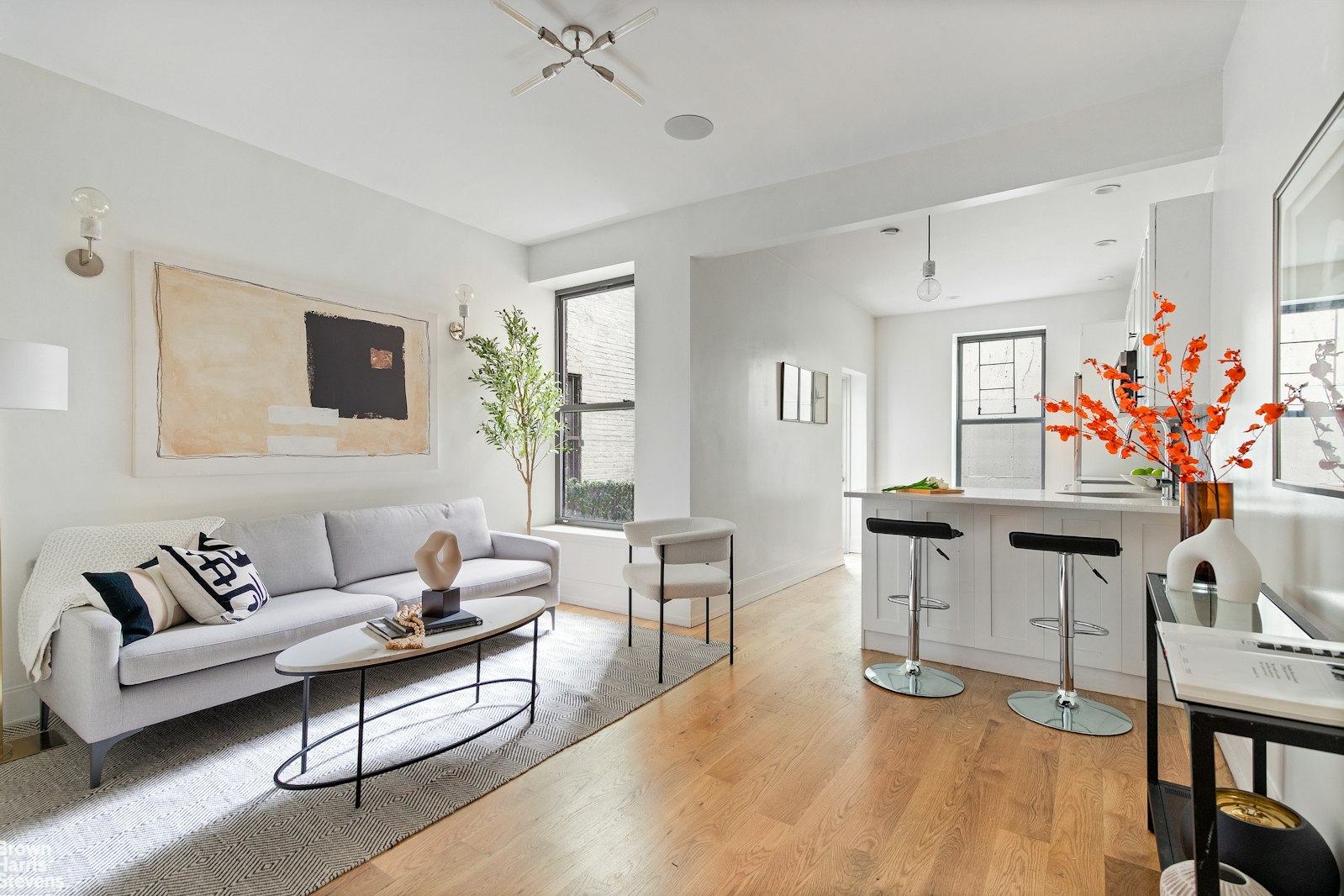 a living room with furniture a flat screen tv and a table