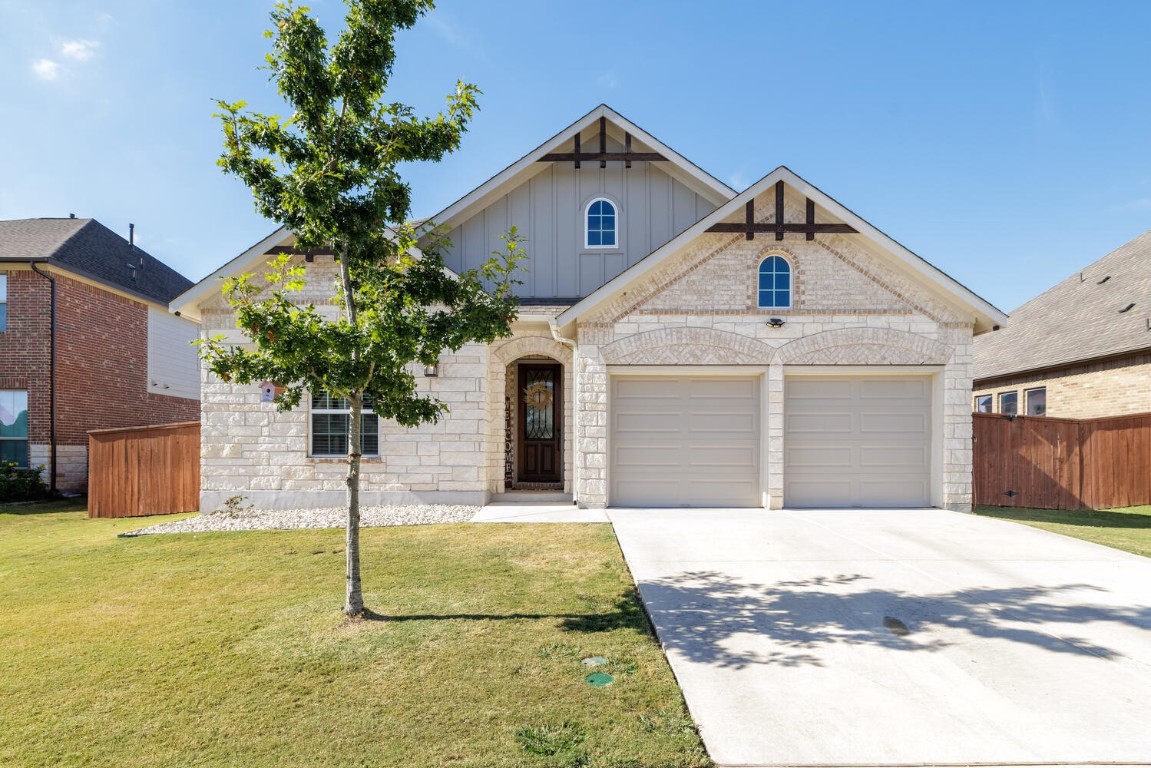 a front view of a house with a yard garage and window