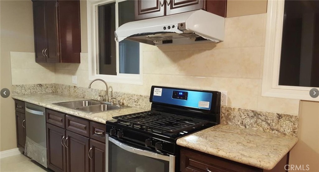 a kitchen with a sink and a stove