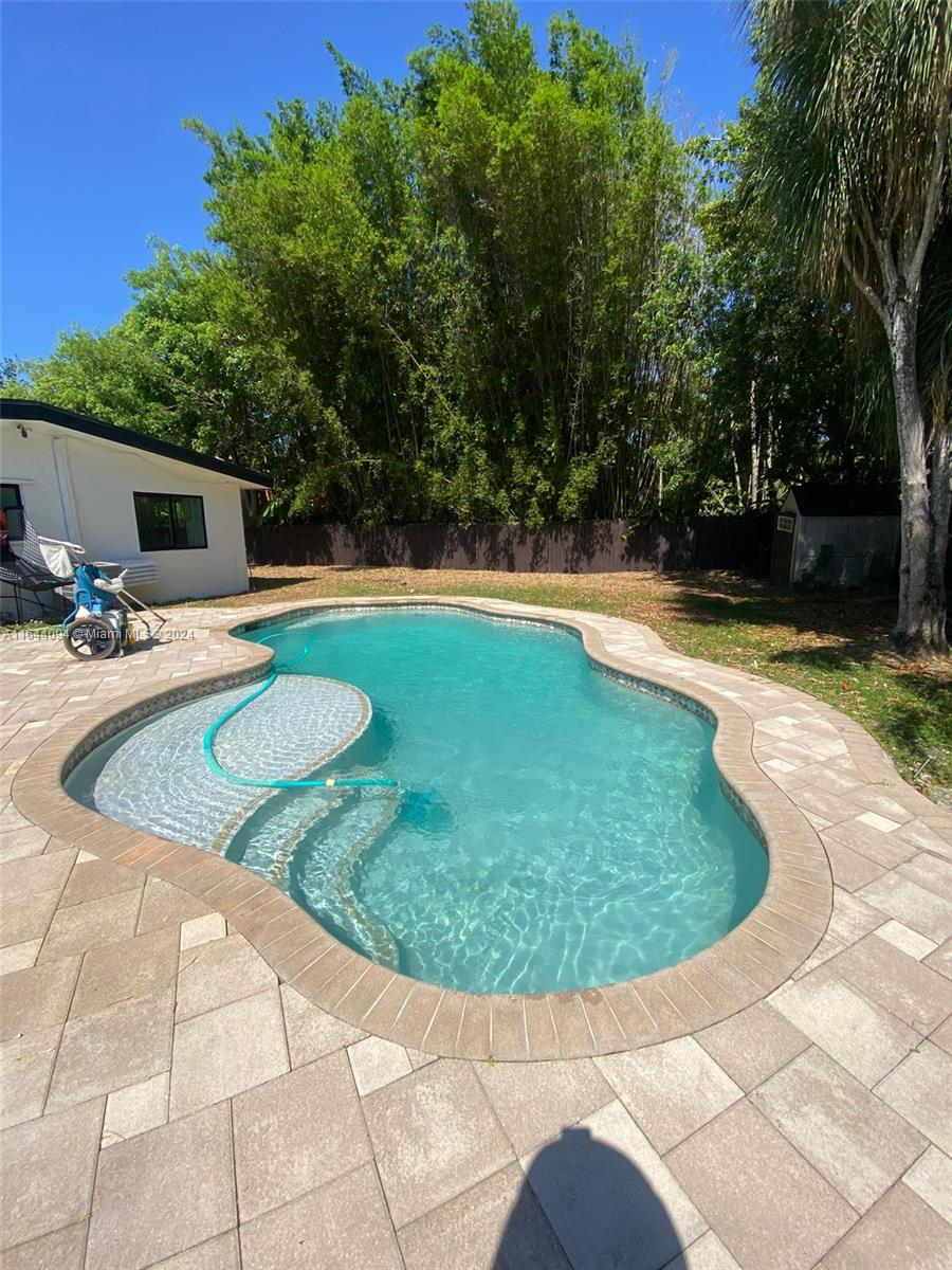 a view of a swimming pool with a yard