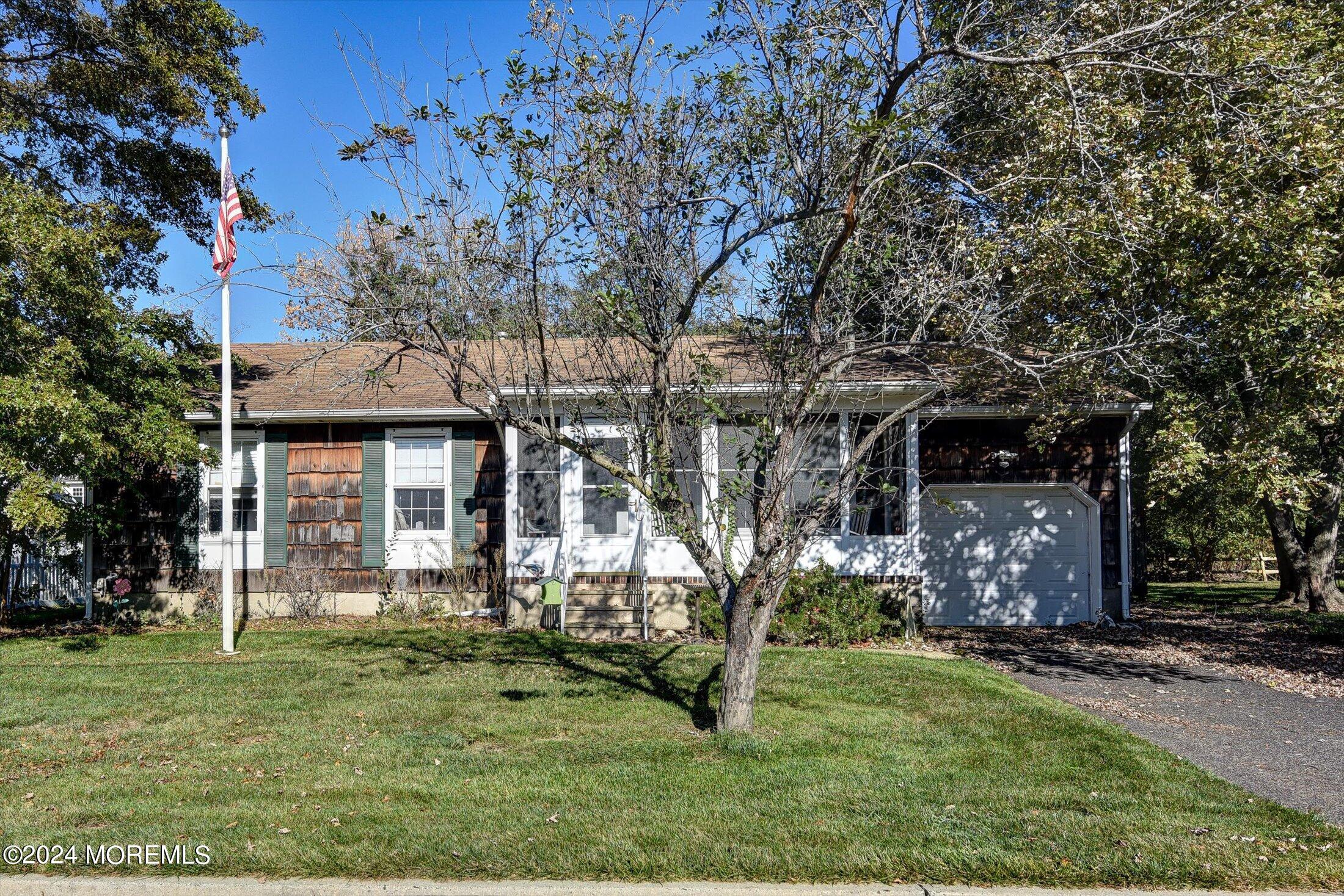 front view of a house with a tree in a yard