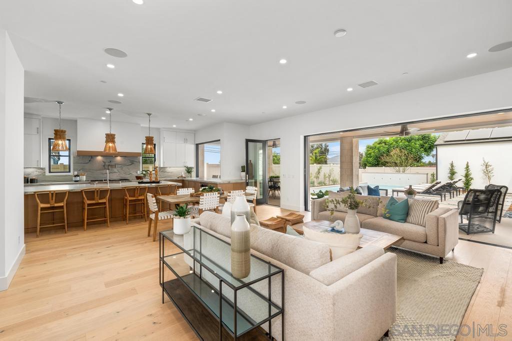 a living room with lots of furniture and white appliances