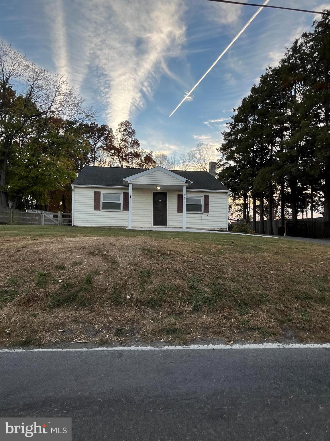 a front view of house with yard and trees