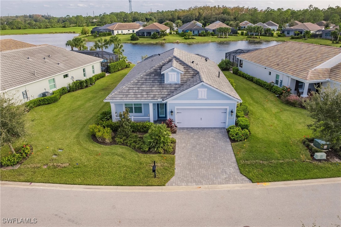 an aerial view of a house with a garden and lake view