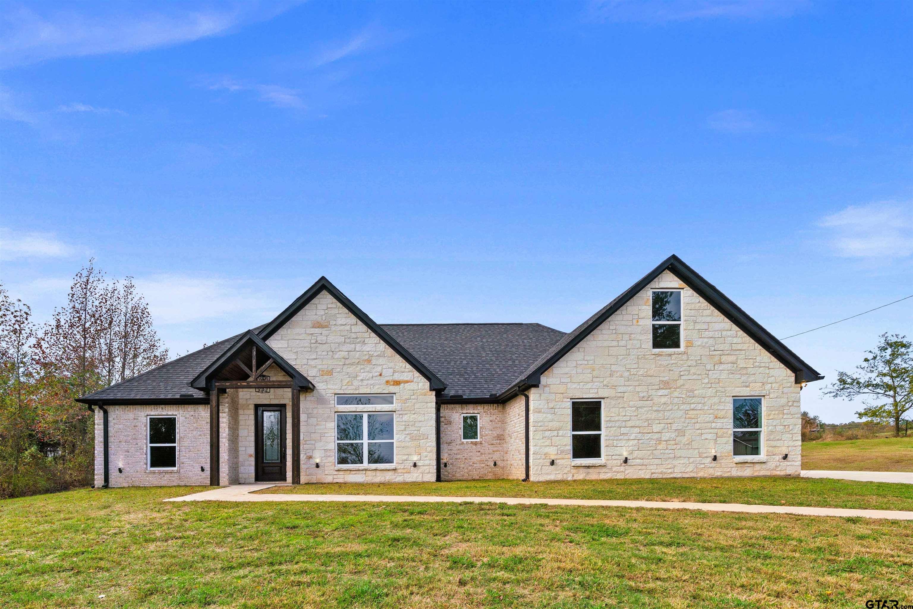 a front view of house with yard and green space