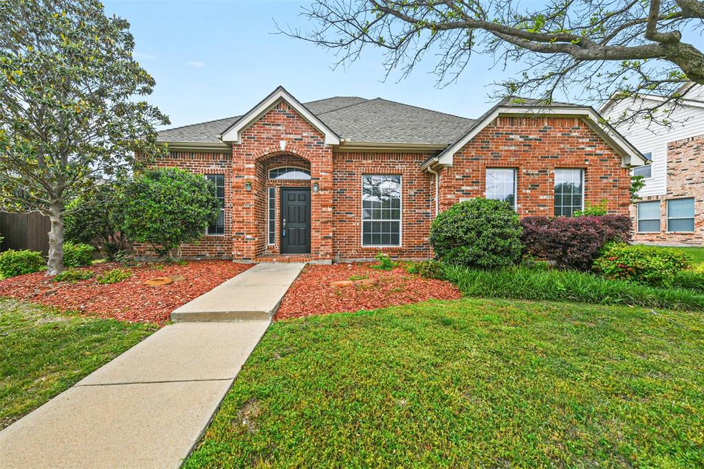 a front view of a house with yard