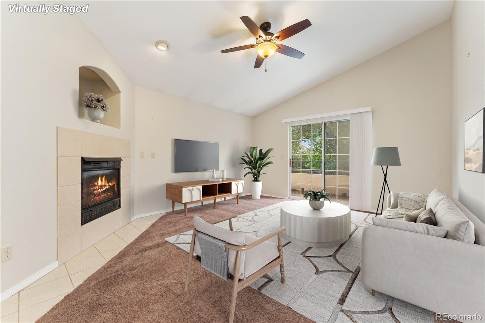 a living room with furniture a fireplace and a flat screen tv