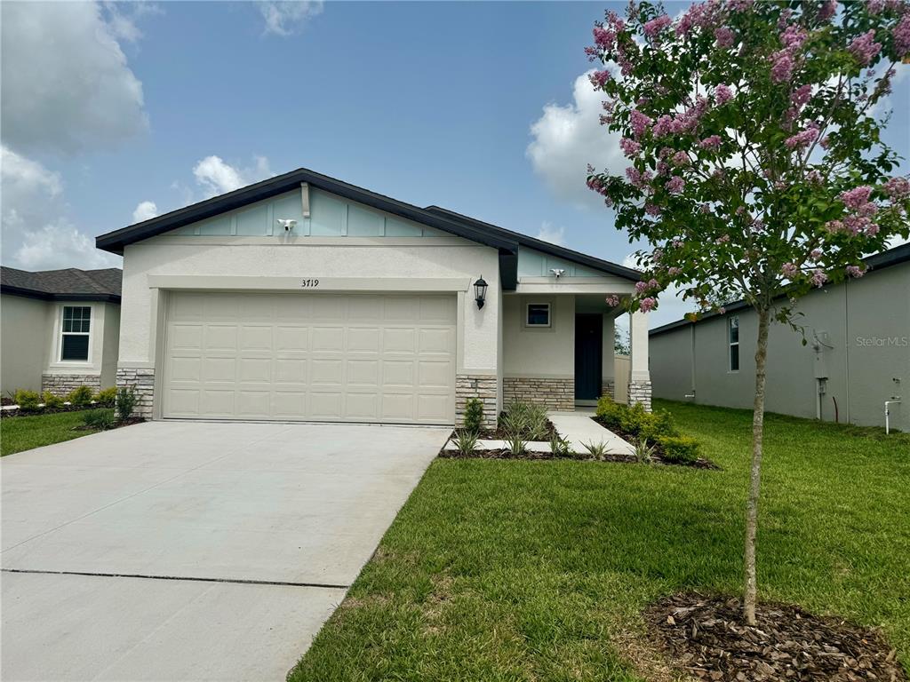 a front view of house with yard and green space