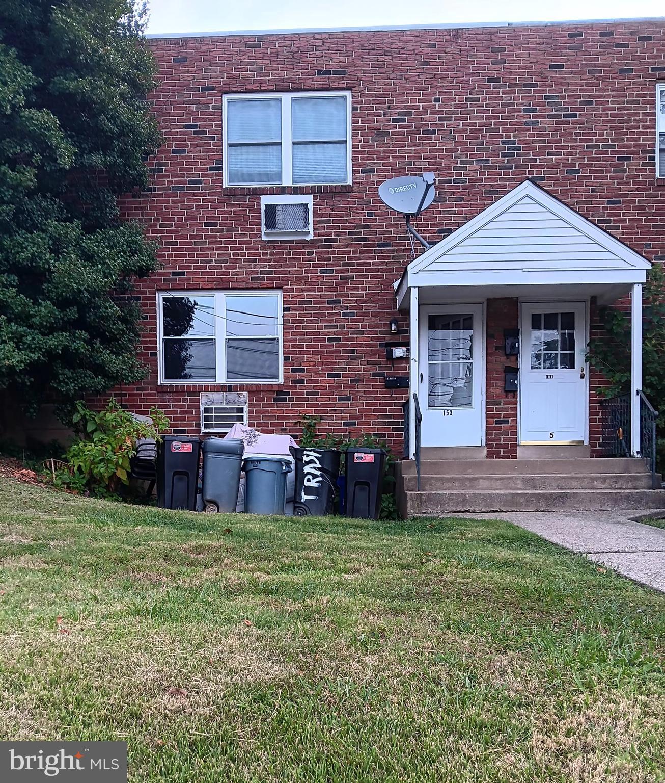 a view of a brick house with a yard