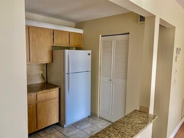 a kitchen with a refrigerator and a sink