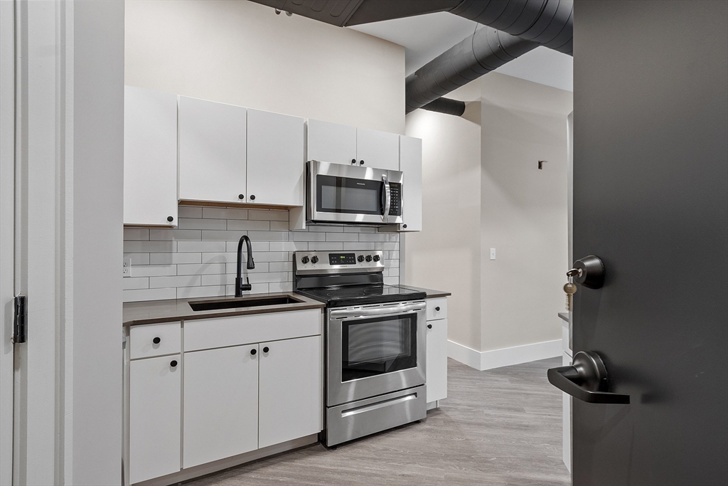 a kitchen with appliances cabinets and a sink