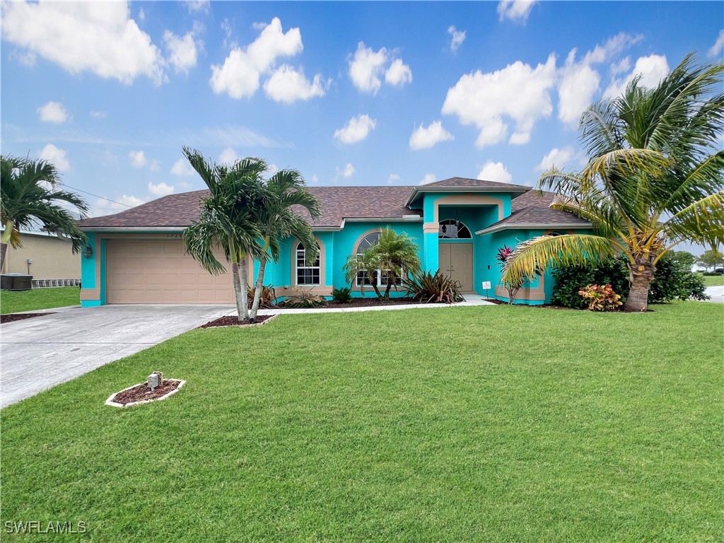 a front view of house with yard and outdoor seating