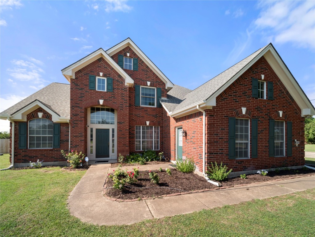 a front view of a house with a yard