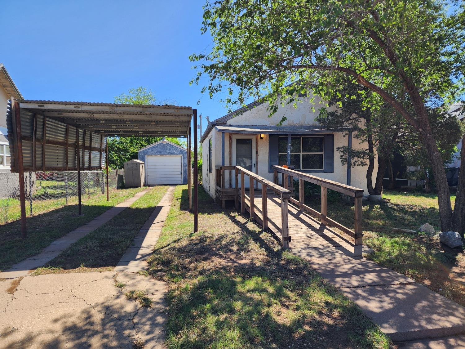 a view of a house with backyard porch and sitting area