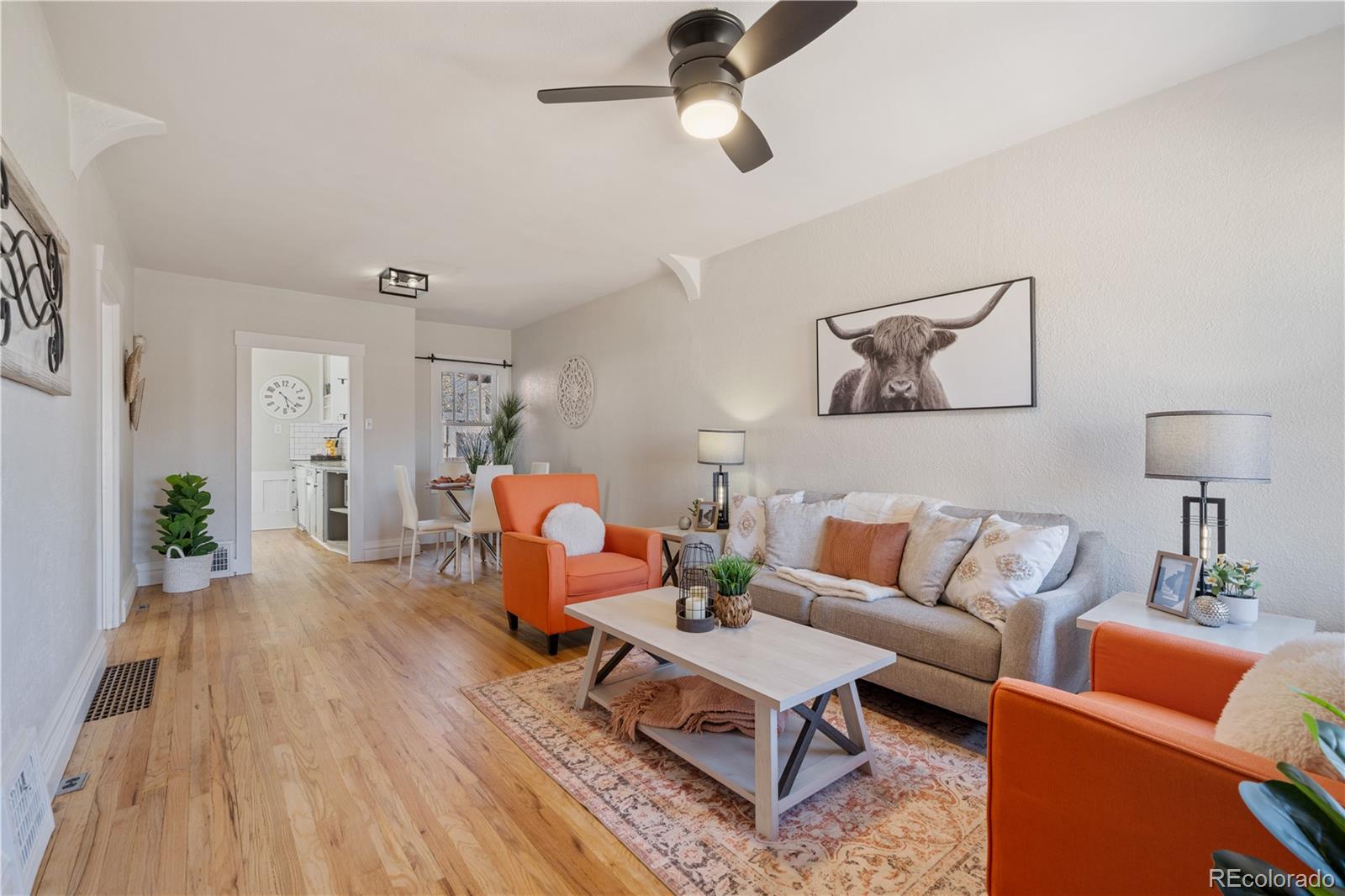 a living room with furniture and wooden floor