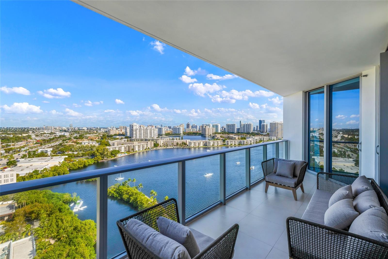 a view of a balcony with furniture and a floor to ceiling window