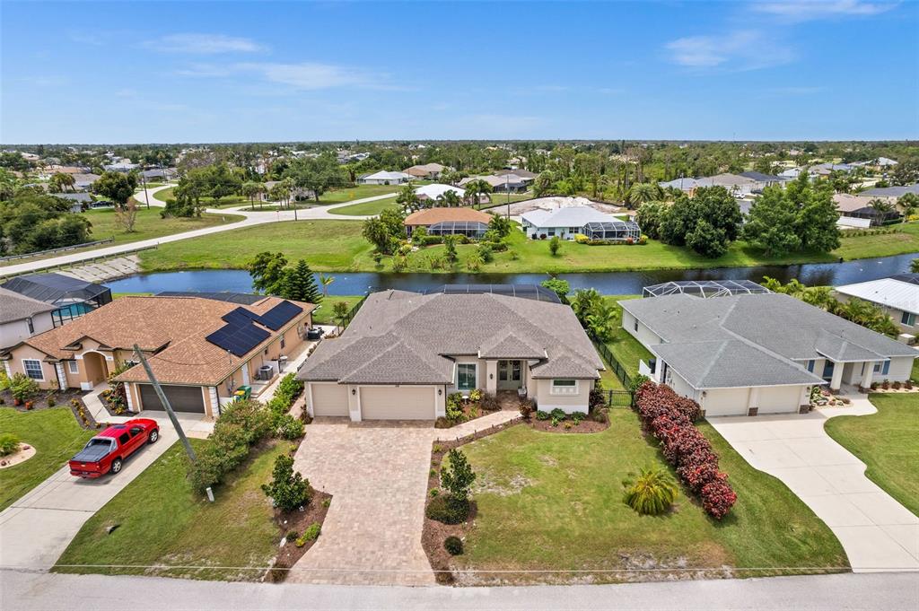 an aerial view of residential houses with outdoor space and ocean view