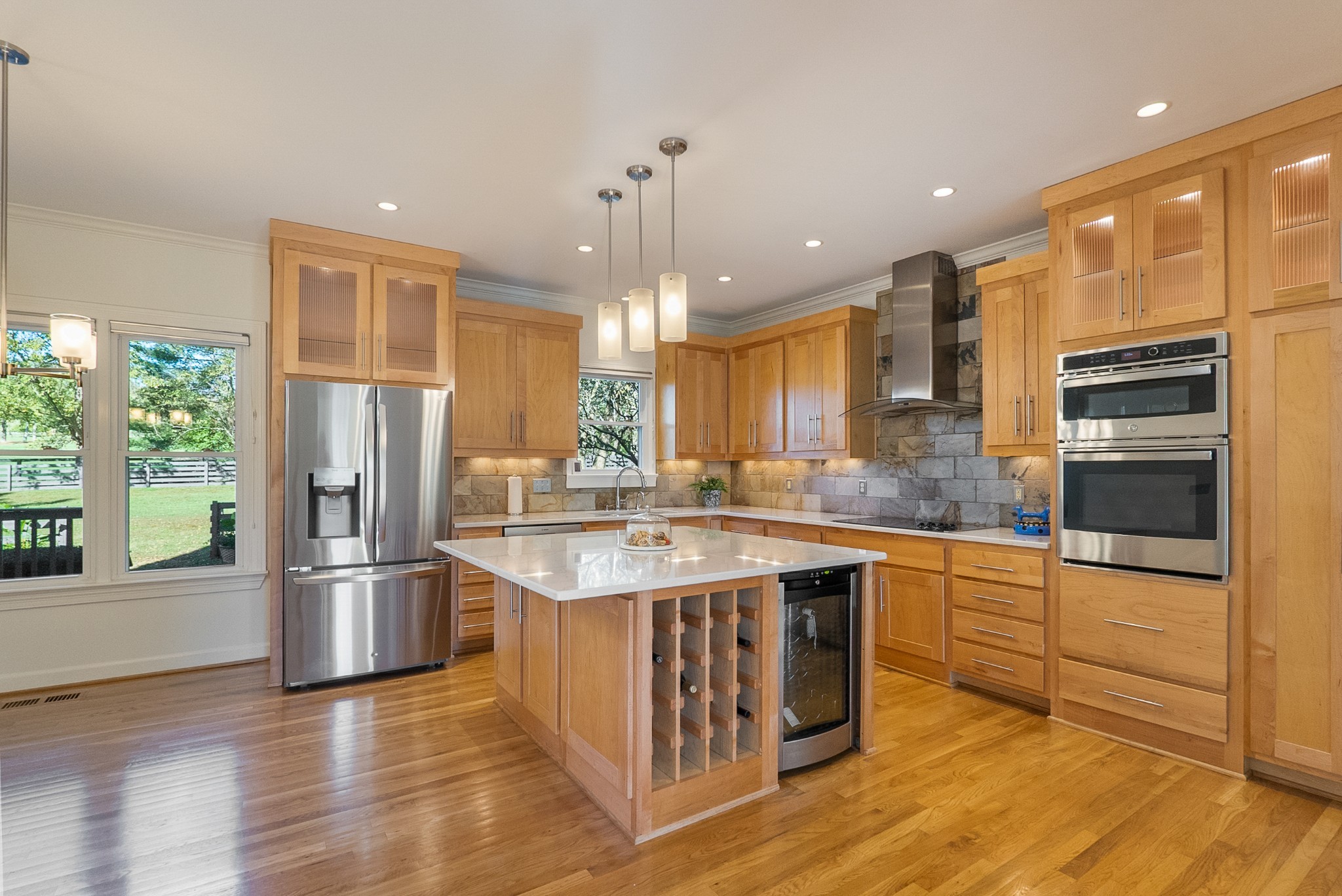 Fully renovated kitchen with sleek stainless steel appliances, including a convenient mini beverage fridge for added luxury. Kitchen quartz counter tops,sink, oven, and microwave added Oct ‘24 Dishwasher and refrigerator added in 2021