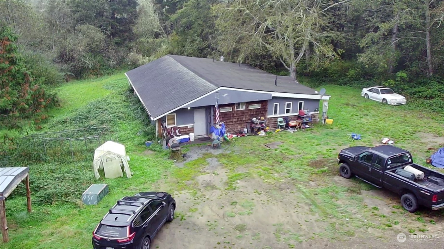 a backyard of a house with table and chairs