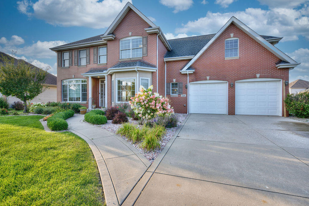 a front view of a house with a yard and garage