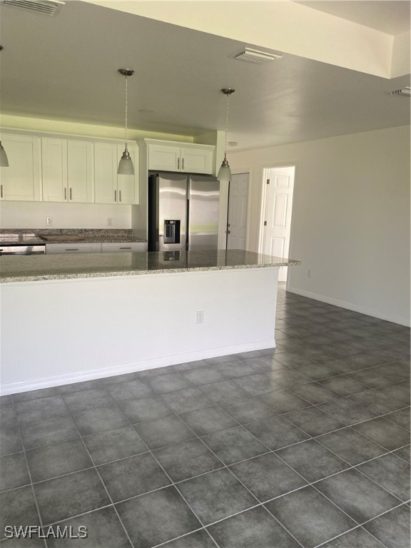 a view of a kitchen with kitchen sink and refrigerator