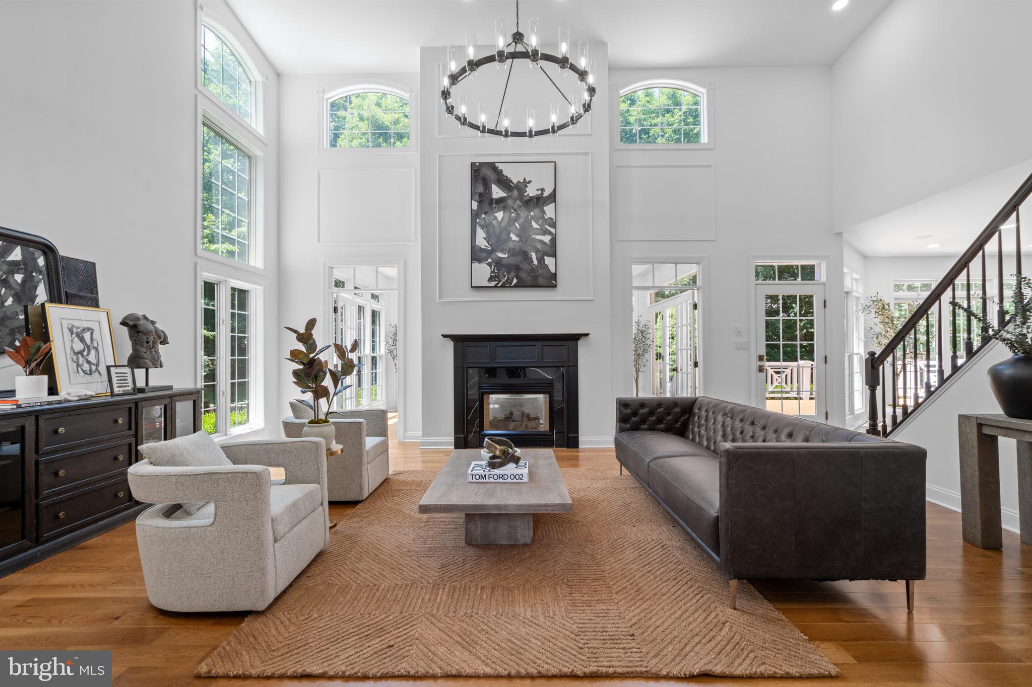 a living room with fireplace furniture and a wooden floor