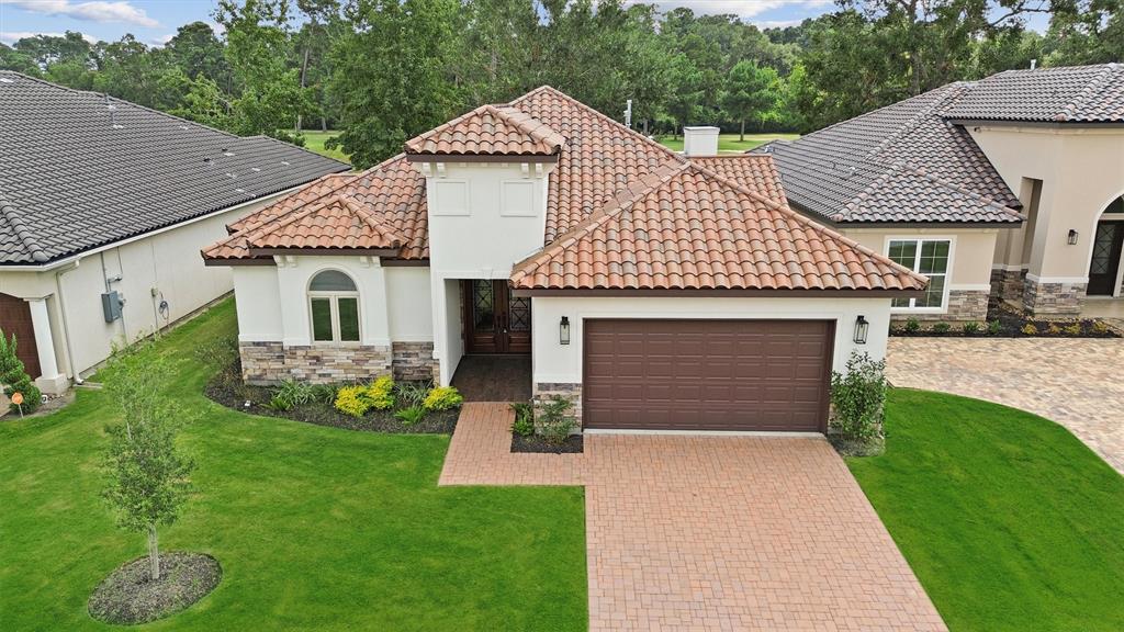 a front view of a house with a garden and yard