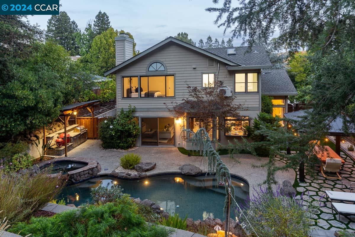 a front view of house with yard and lake view