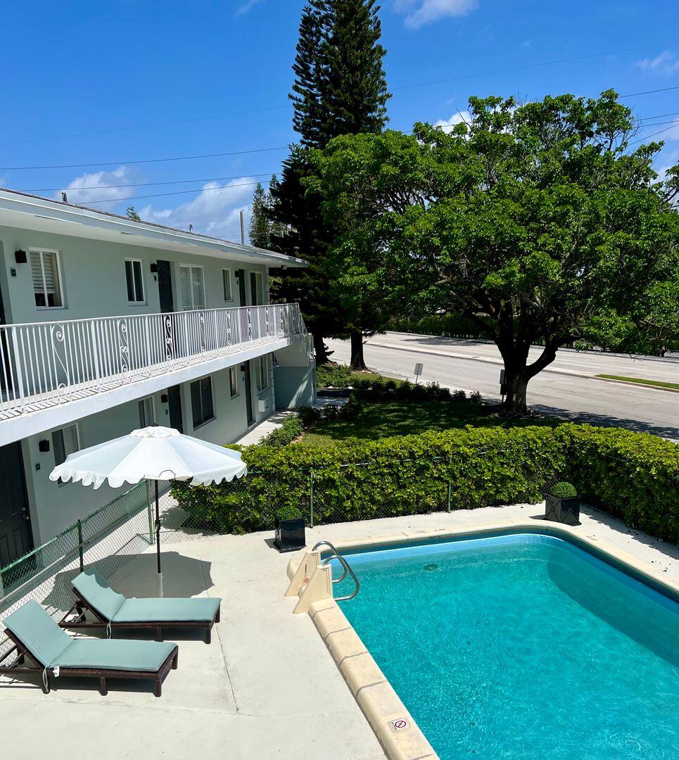 a front view of a house with a yard balcony and outdoor seating